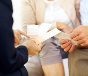 Couple looking at paint samples with a consultant